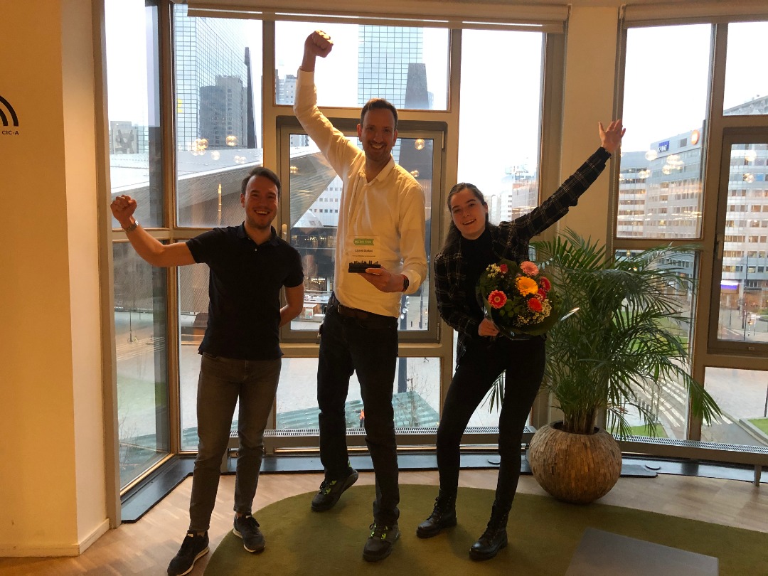 Lizard global's ceo celebrating winning an award with 2 employees; within the rotterdamn office