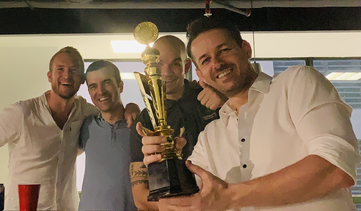 Markus and Terrence celebrating an award with Gudio who is holding the award trophy; in kuala lumpur