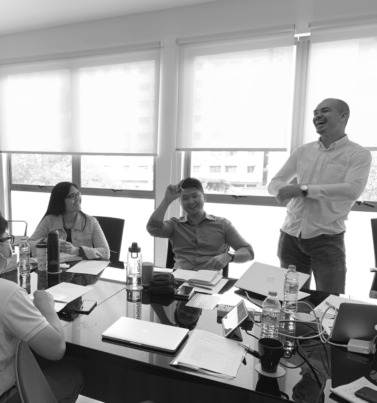 A picture of terrence with clients in a meeting